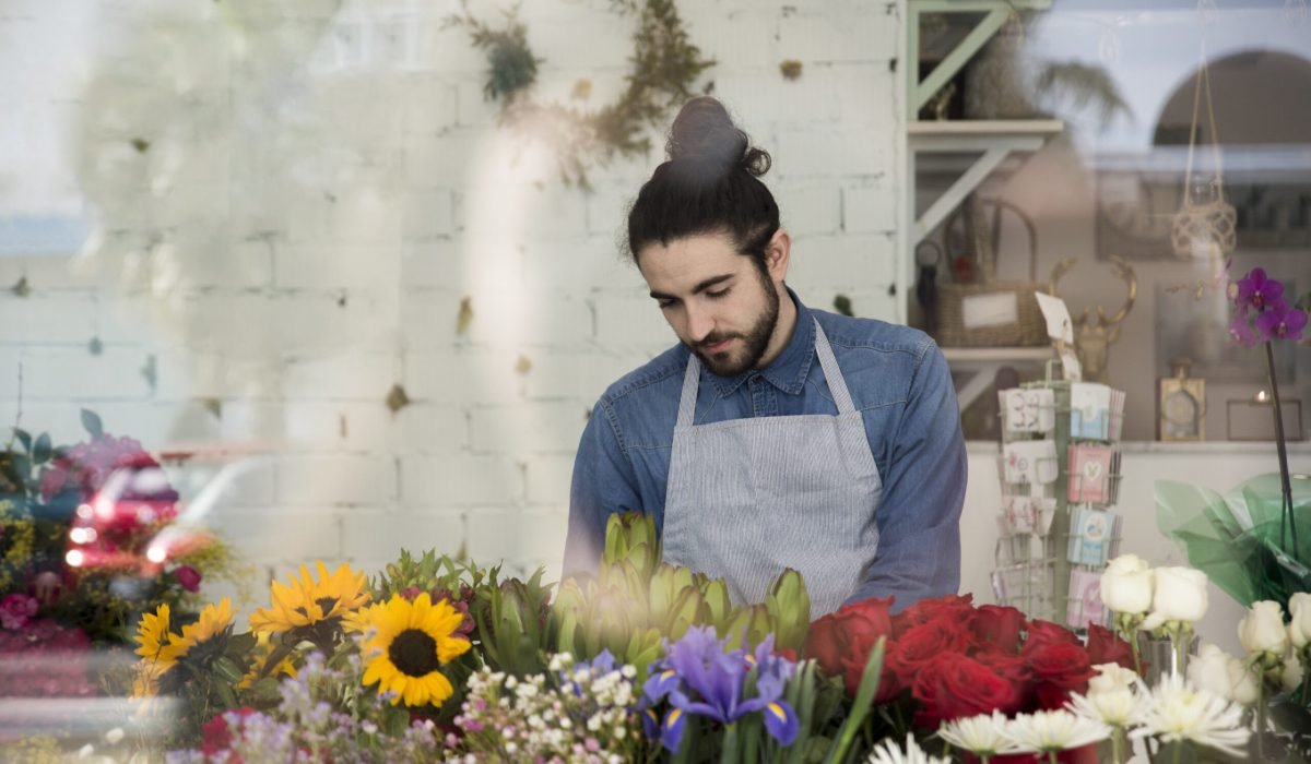 portrait-male-florist-standing-colorful-flowers-flower-shop